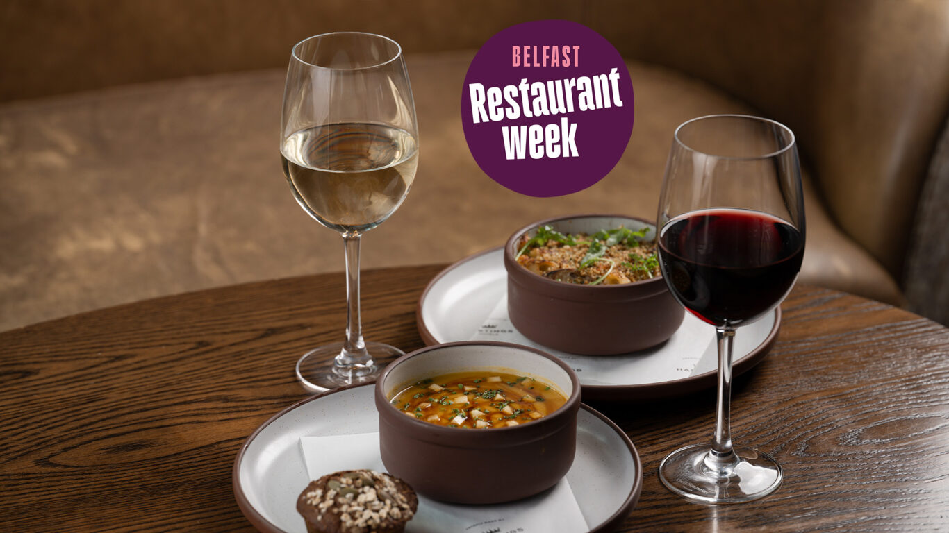 Belfast Restaurant Week starters on a table - Conway Farm Crown Prince Pumpkin Soup and Annaghmore Mushroom & Truffle Mac and Cheese, accompanied with a glass of red and white wine